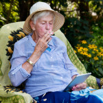 Happy senior woman smoking marijuana