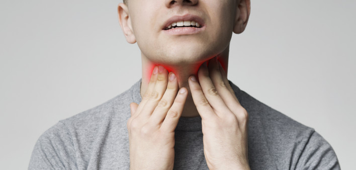 Young man pulping his inflamed neck