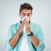 man blowing nose