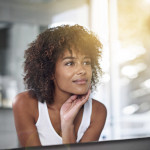 An African American woman looking in a mirror