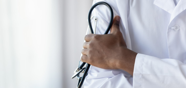 Male african american black professional doctor physician general practitioner wear white medical coat holding stethoscope, medicine and health care