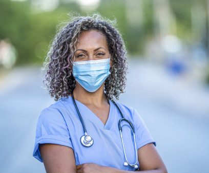 Portrait of an African American nurse wearing a protective face mask to avoid the transfer of germs during the COVID-19 outbreak.
