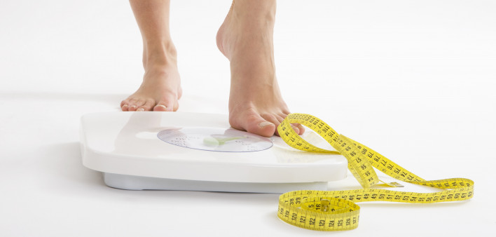 bare feet on scale and measuring tape