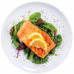 plate with salmon on greens