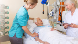 Senior patient in hospital bed nurse