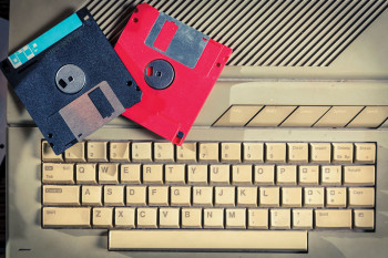 old computer keyboard and floppy disks
