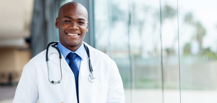 happy african male doctor with tablet computer