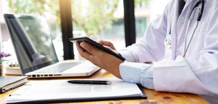 professional doctor use computer and tablet