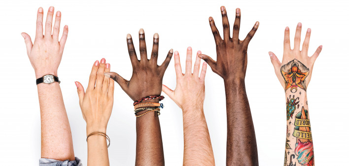 different race hands reaching upward