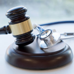 Gavel and stethoscope. medical jurisprudence. legal definition of medical malpractice. attorney. common errors doctors, nurses and hospitals make