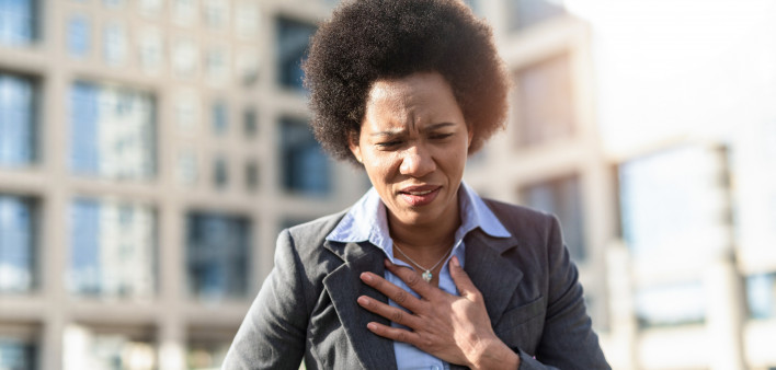 Mid adult African American woman having difficulties breathing.