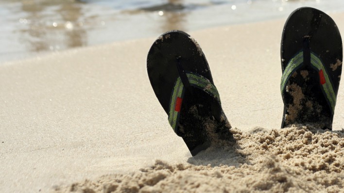 flip flops at beach and women in bikinis