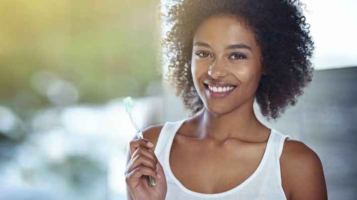 Woman holding toothbrush