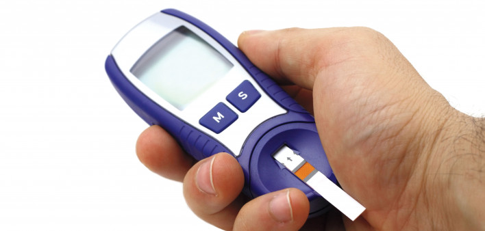 hand holding glucose monitor