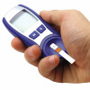 hand holding glucose monitor