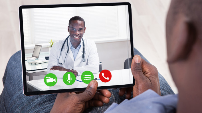 Close-up Of African Person Holding Blank Digital Tablet