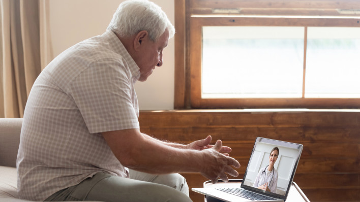 Elderly man make distant video call communicating with doctor online s