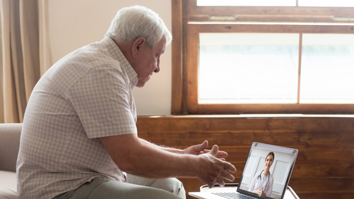 Elderly man make distant video call communicating with doctor online s