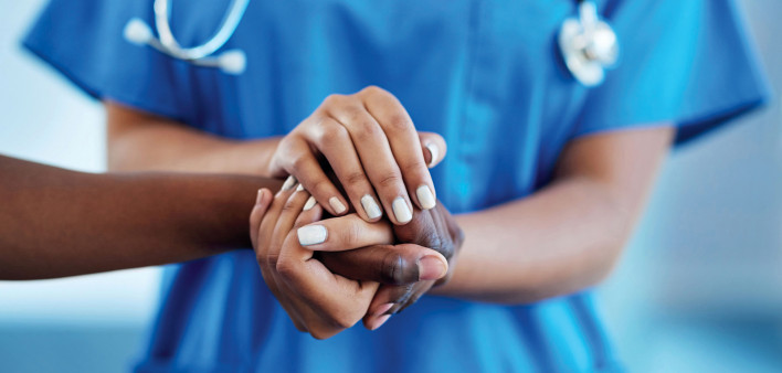 nurse's hands holding patients hands