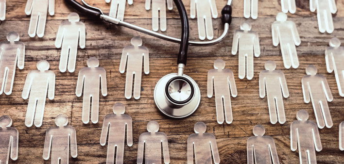 photo illustration figures and stethoscope on wood