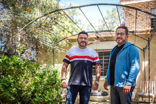 Two Latino men standing in backyard in Uruguay, the man on the right is living with HIV