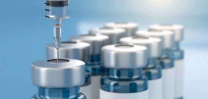 vaccnie viles and needle going into vial