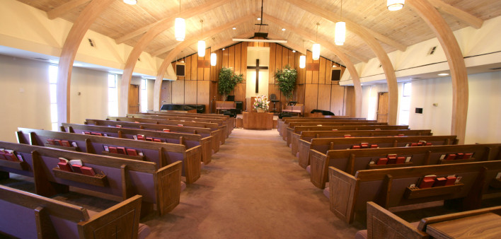 Sanctuary of a small church with pews and pulpit