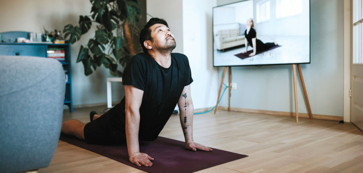 man doing yoga with zoom instruction