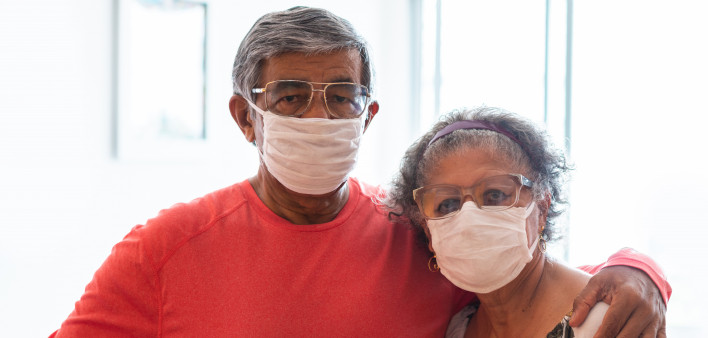 Senior couple wearing protective mask against infectious diseases
