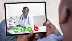 Close-up Of African Person Holding Blank Digital Tablet