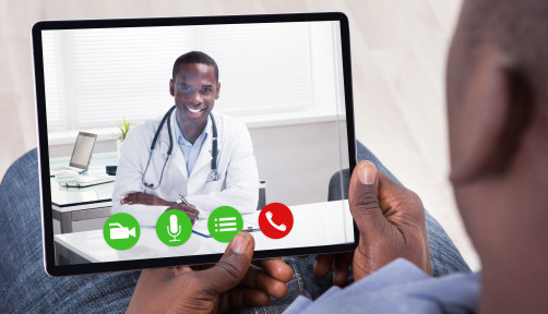 Close-up Of African Person Holding Blank Digital Tablet