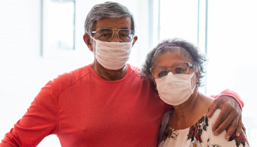Senior couple wearing protective mask against infectious diseases