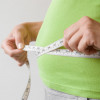 hands measuring waist measuring tape
