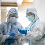 Asian doctor checking coronavirus or covid-19 infected patient in quarantine room