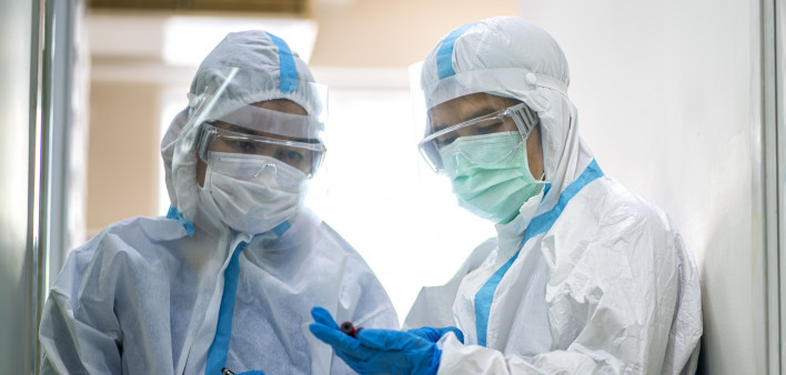 Asian doctor checking coronavirus or covid-19 infected patient in quarantine room