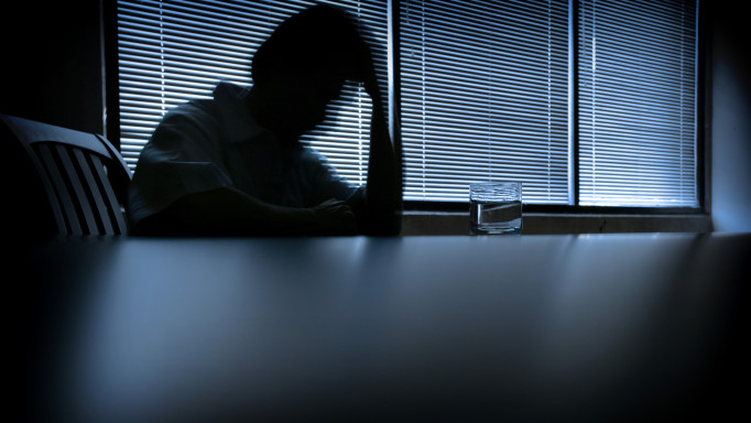 depressed man in a dark room 