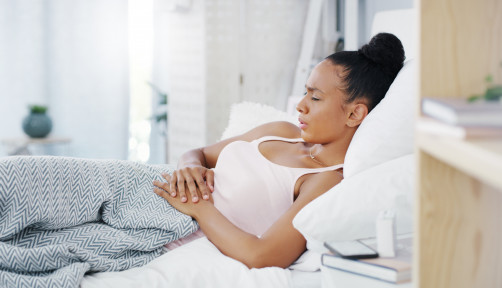 woman girl stomach cramps couch