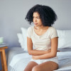 woman girl stomach cramps bed