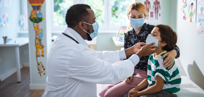 Close up of a pediatrician having a check up on his patient