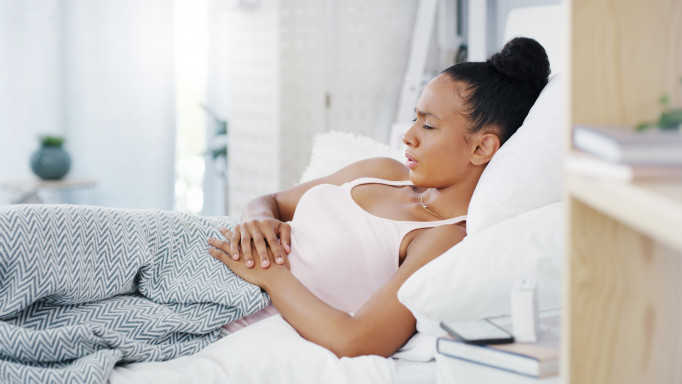 woman girl stomach cramps couch