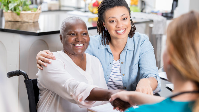 mother daughter talking to doctor smiling