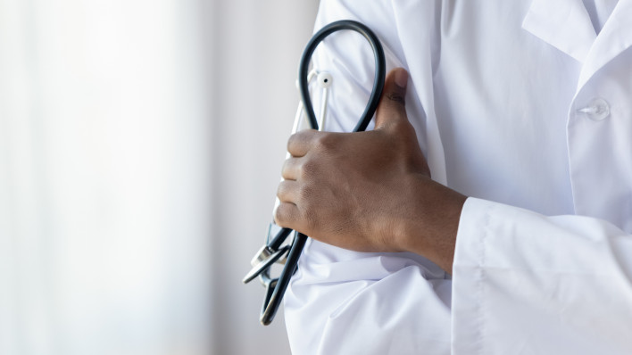 Male african american black professional doctor physician general practitioner wear white medical coat holding stethoscope, medicine and health care