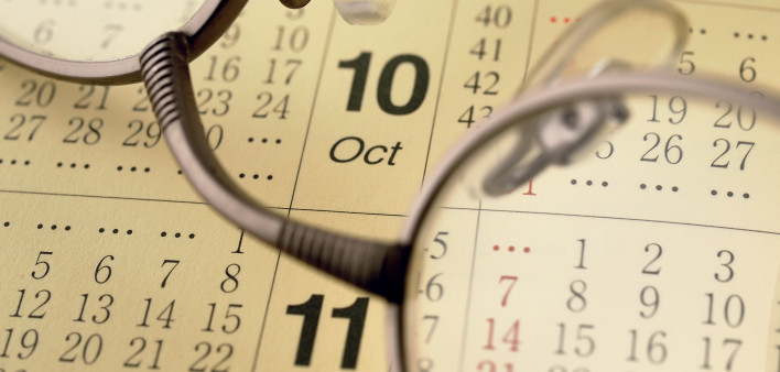 a pair of glassses on top of a calendar