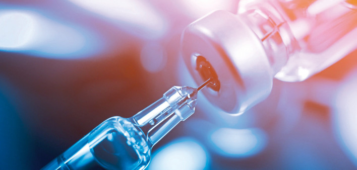 needle going into a vial vaccine medication