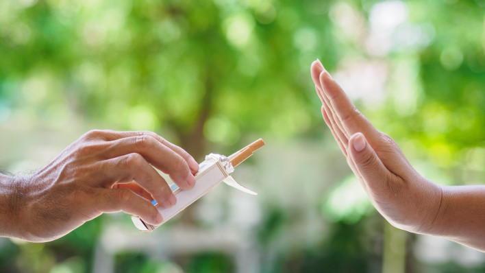 lose up of male hands holding cigarettes and proposing it to person.