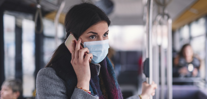 Young Woman With Face Mask Talking On The Phone