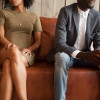 african american couple sitton on couch