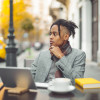 African American young man working outside at cafe