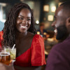 Couple On Date Sitting At Bar Counter And Talking