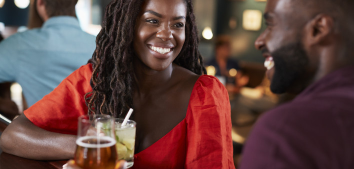 Couple On Date Sitting At Bar Counter And Talking